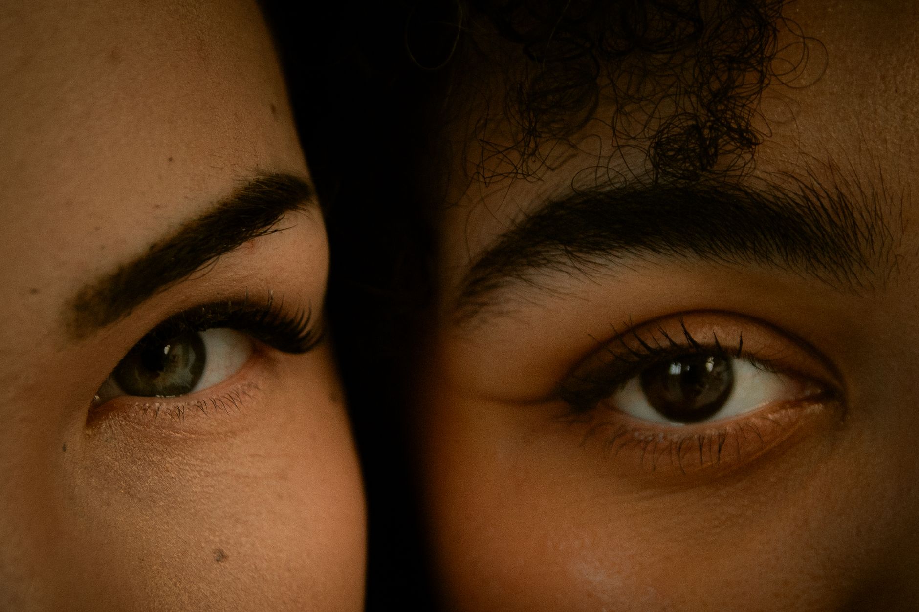 Two people facing each other with steady, unflinching eye contact during conversation.