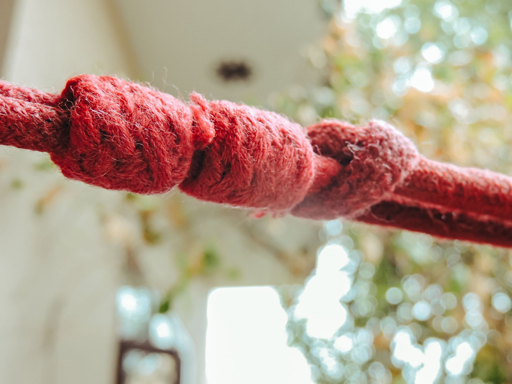 Twisted thread with multiple knots and loops creating confusion and complexity.